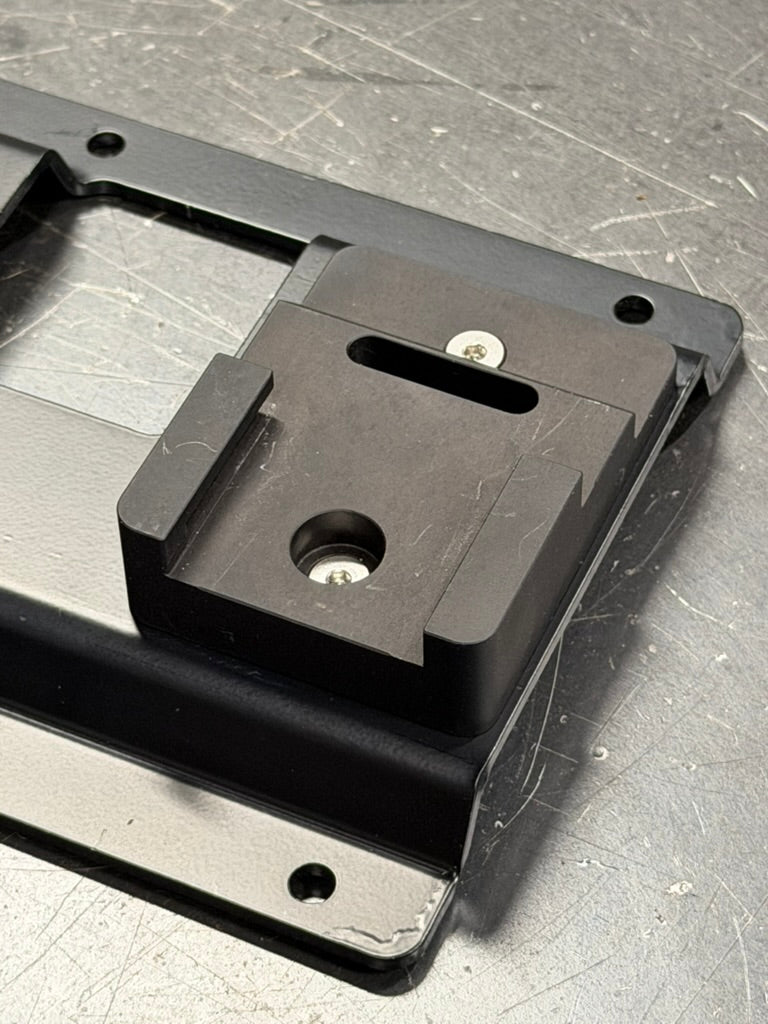 Close-up of a holder block bolted to the Keepfast rack
