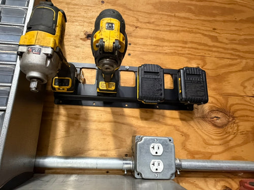 Keepfast 4-slot rack on a shop wall holding DeWalt 20V tools and batteries