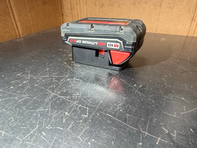 Milwaukee M18 battery hanging upside down in a Keepfast battery holder