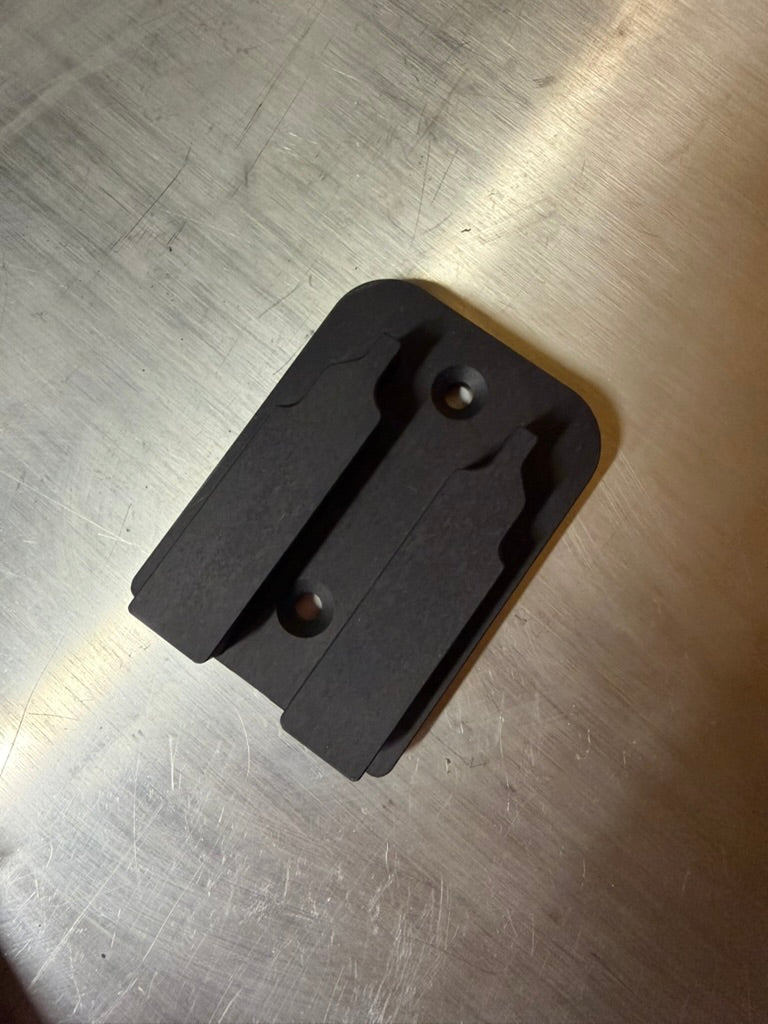 Keepfast tool holder for DeWalt 20V, top view showing countersunk mounting holes