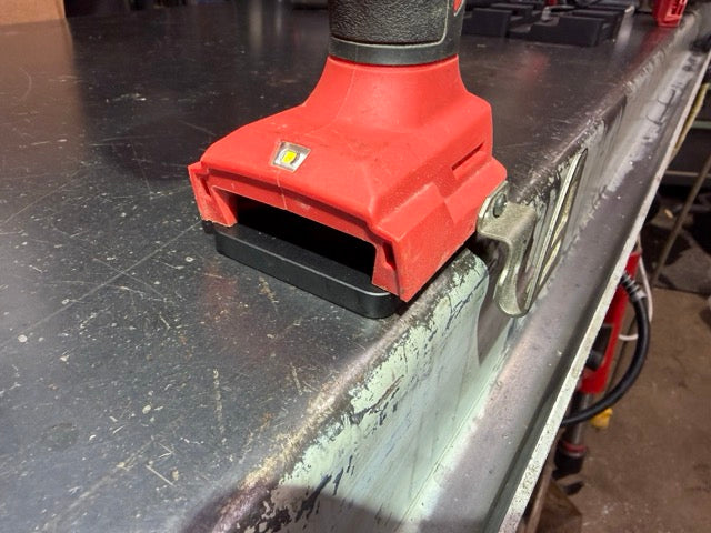 Milwaukee M18 impact wrench seated on a Keepfast tool holder, front view